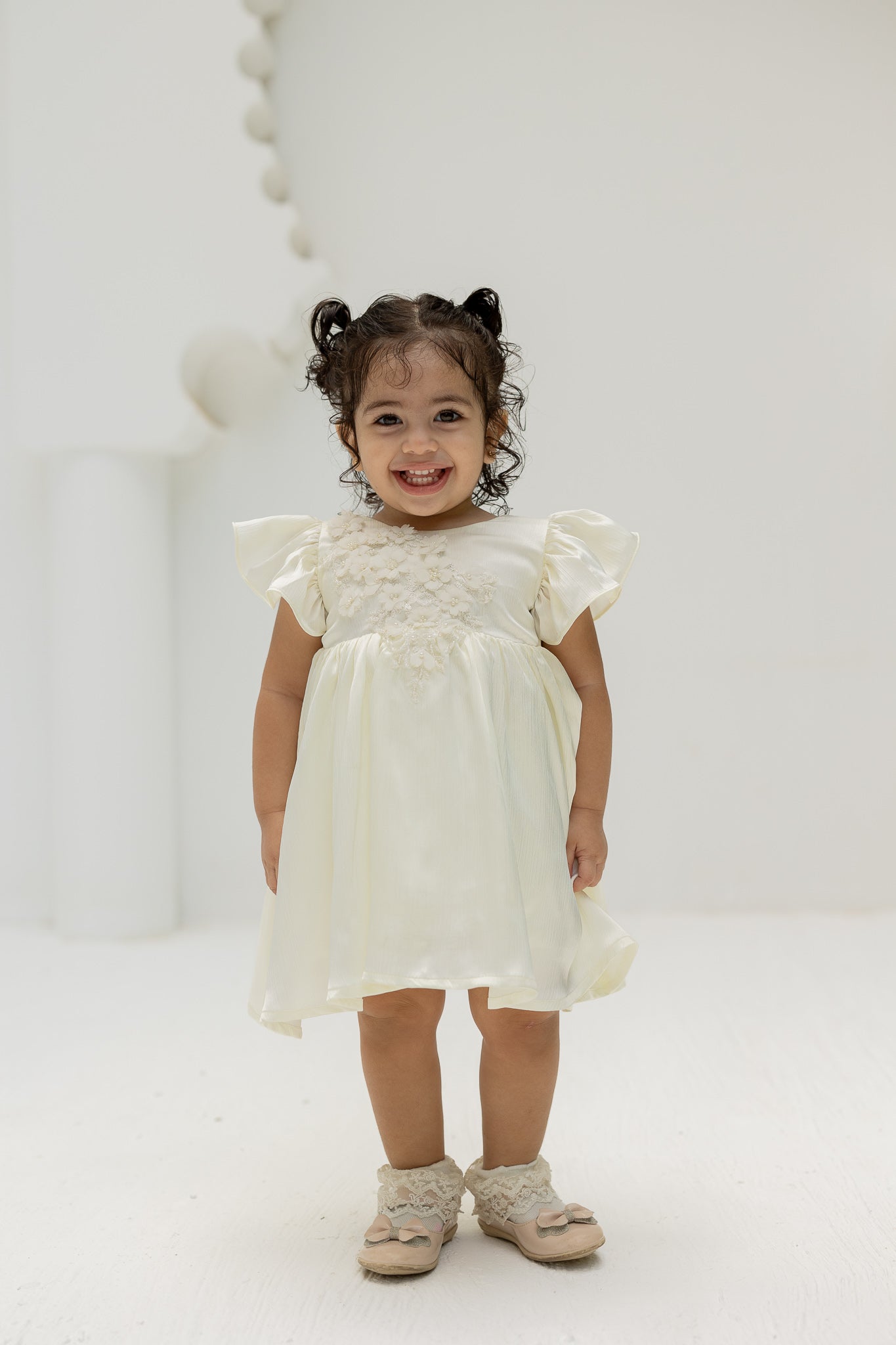 Ivory Blossom Baby Dress with Floral Embellishments