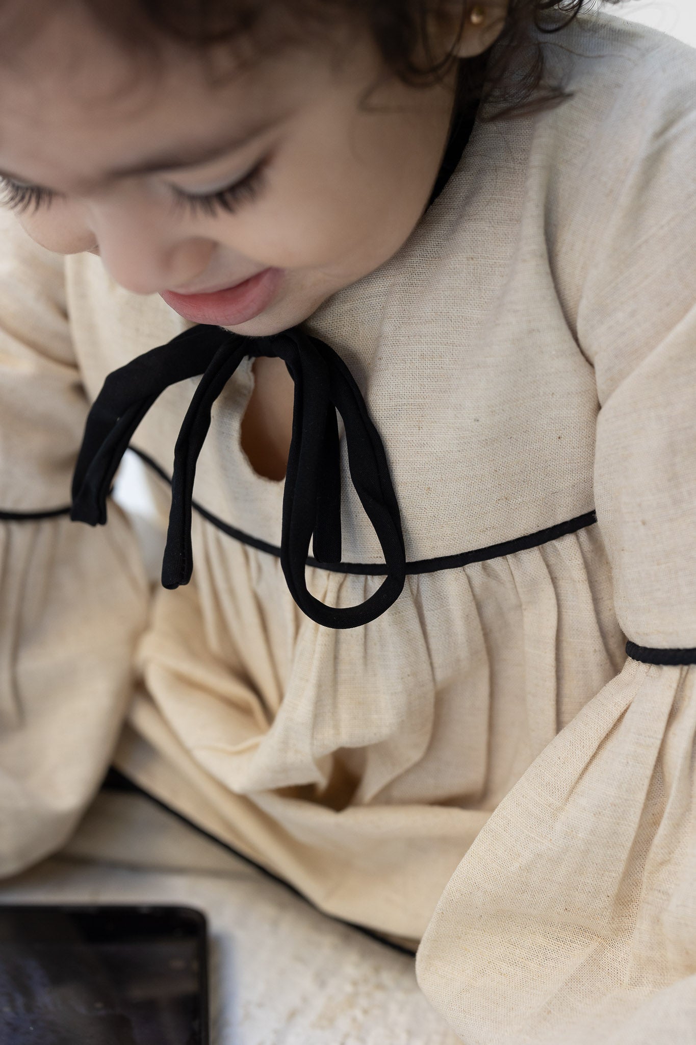 Eclipse Cream Baby Dress with Black Trim and Bow Detail